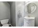 Elegant bathroom with modern vanity, stylish mirror, and neutral gray wall paint at 1921 Harrison Park Dr, Atlanta, GA 30341