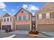 Charming brick townhome featuring a two-car garage and well-maintained landscaping at 1921 Harrison Park Dr, Atlanta, GA 30341