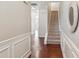 Inviting hallway featuring hardwood floors and classic white wainscoting at 1921 Harrison Park Dr, Atlanta, GA 30341