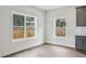 Bright nook with large windows offering wooded views, hardwood floors, and gray cabinets, perfect for casual dining at 3127 Stonegate Sw Dr, Atlanta, GA 30331