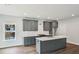 Modern kitchen featuring gray cabinets, an island with white countertop, and stainless steel appliances at 3127 Stonegate Sw Dr, Atlanta, GA 30331