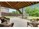 Outdoor patio with cozy seating area, overlooking a serene backyard with stairs and a lush lawn at 3286 Sweetleaf Ln, Buford, GA 30519