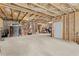Unfinished basement offering plenty of storage with exposed insulation, wood framing, and concrete flooring at 3286 Sweetleaf Ln, Buford, GA 30519