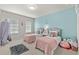 Bright bedroom featuring two beds and a cool-toned accent wall at 3286 Sweetleaf Ln, Buford, GA 30519
