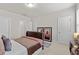 Bright bedroom with neutral tones, plush carpet, and featuring two entry doors at 3286 Sweetleaf Ln, Buford, GA 30519