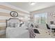 Charming bedroom featuring striped walls, plush bedding, decorative teepee, and bright natural light at 3286 Sweetleaf Ln, Buford, GA 30519