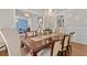 Formal dining room with chandelier, decorative wallpaper, and wainscoting creates an inviting space for meals at 3286 Sweetleaf Ln, Buford, GA 30519