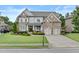 Beautiful two-story brick home featuring a well-maintained lawn, two-car garage, and inviting front entrance at 3286 Sweetleaf Ln, Buford, GA 30519