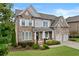 Beautiful two-story brick home with manicured lawn, welcoming entrance, and attached two-car garage at 3286 Sweetleaf Ln, Buford, GA 30519