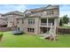 Rear exterior of home with covered porch, a fenced yard, and beautiful landscaping at 3286 Sweetleaf Ln, Buford, GA 30519