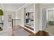 Upstairs hallway with hardwood flooring, neutral paint, and views into other living spaces at 3286 Sweetleaf Ln, Buford, GA 30519