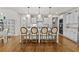 Spacious kitchen with an island, white cabinets, stainless steel appliances, and eat in breakfast area at 3286 Sweetleaf Ln, Buford, GA 30519