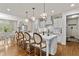 Bright eat-in kitchen with a large island, white cabinets, stainless steel appliances and hardwood floors at 3286 Sweetleaf Ln, Buford, GA 30519
