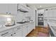 Stylish kitchen featuring white cabinets, subway tile backsplash, stainless steel appliances and quartz countertops at 3286 Sweetleaf Ln, Buford, GA 30519