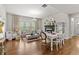 Cozy living room with a fireplace, large windows, and hardwood floors at 3286 Sweetleaf Ln, Buford, GA 30519
