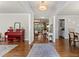 Open-concept living space with hardwood floors and neutral tones, connecting seamlessly to the adjacent dining area at 3286 Sweetleaf Ln, Buford, GA 30519