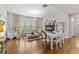 Bright living room featuring a fireplace, large windows and hardwood floors at 3286 Sweetleaf Ln, Buford, GA 30519
