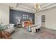 The main bedroom features a decorative tray ceiling, stylish furniture, and a view leading to the bathroom at 3286 Sweetleaf Ln, Buford, GA 30519