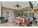 Relaxing covered patio with outdoor seating, ceiling fan, and brick accents ideal for entertaining at 3286 Sweetleaf Ln, Buford, GA 30519