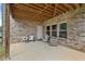 Covered patio area with brick walls and outdoor seating perfect for relaxing in any weather at 3286 Sweetleaf Ln, Buford, GA 30519
