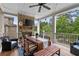 Charming covered patio with a cozy fireplace, tv, and outdoor dining area, perfect for gatherings at 3286 Sweetleaf Ln, Buford, GA 30519