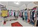 Large walk-in closet has rows of shelving and rods to store clothing with a patterned rug on the floor at 3286 Sweetleaf Ln, Buford, GA 30519
