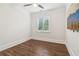 A bright bedroom showcases wood floors, a large window, and a modern ceiling fan at 1098 Briar Cove Cir, Atlanta, GA 30329