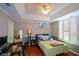 Cozy bedroom with tray ceilings, hardwood floors, and a computer desk for work or study at 1315 Mcgill Park Ne Ave, Atlanta, GA 30312