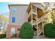 Tan condo building with brick accents and wooden staircases and balconies at 1315 Mcgill Park Ne Ave, Atlanta, GA 30312