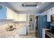 Well-lit kitchen with stainless steel appliances, granite counters, and convenient laundry access at 1315 Mcgill Park Ne Ave, Atlanta, GA 30312