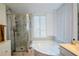 Bright main bathroom featuring a luxurious tub, separate glass shower, and elegant finishes at 1315 Mcgill Park Ne Ave, Atlanta, GA 30312