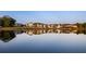 Scenic water view reflecting the neighborhood homes in the still water, surrounded by lush greenery at 215 Rolison Way, Fayetteville, GA 30214