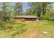 View of the serene backyard with lush greenery and mature trees, showcasing the home's connection to nature at 244 Hurt Se Dr, Smyrna, GA 30082