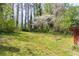 View of the serene backyard with lush greenery and mature trees, providing a peaceful outdoor space at 244 Hurt Se Dr, Smyrna, GA 30082