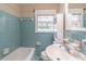 Bathroom with bathtub, toilet and sink with neutral color palette and window with blind, offering natural light at 244 Hurt Se Dr, Smyrna, GA 30082