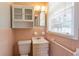 Small bathroom with toilet, sink and window providing natural light, along with some cabinet space at 244 Hurt Se Dr, Smyrna, GA 30082