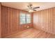 Wood paneled bedroom with hardwood floors and a window with natural light at 244 Hurt Se Dr, Smyrna, GA 30082
