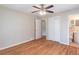 Bedroom featuring hardwood floors, ceiling fan, double closet and views into the hall and nearby bathroom at 244 Hurt Se Dr, Smyrna, GA 30082