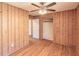 Bedroom with wood paneling and a ceiling fan at 244 Hurt Se Dr, Smyrna, GA 30082
