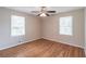 Spacious bedroom features hardwood floors, neutral walls, ceiling fan, and two windows providing ample natural light at 244 Hurt Se Dr, Smyrna, GA 30082