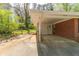 View of a single carport attached to a brick house with a small backyard at 244 Hurt Se Dr, Smyrna, GA 30082