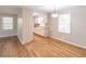 Open dining room and kitchen with hardwood floors and natural light from the windows at 244 Hurt Se Dr, Smyrna, GA 30082