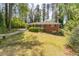 Exterior view of a single story brick home with a green lawn and mature trees at 244 Hurt Se Dr, Smyrna, GA 30082