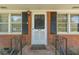 Front door with black shutters and black railing leading up to the porch at 244 Hurt Se Dr, Smyrna, GA 30082