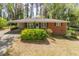 Charming brick home with a well-manicured front yard and inviting carport at 244 Hurt Se Dr, Smyrna, GA 30082