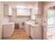 Functional laundry room with washer, dryer, storage cabinets, with exit to backyard at 244 Hurt Se Dr, Smyrna, GA 30082