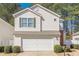 Charming two-story home with white siding, green shutters, and an attached two-car garage at 251 Manley Ct, Woodstock, GA 30188