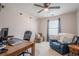 Home office displaying a desk, an office chair, and a blue sofa at 251 Manley Ct, Woodstock, GA 30188