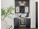 Elegant home bar with custom cabinetry, marble countertop, wine storage, and beverage refrigerator at 255 Marjean Way, Alpharetta, GA 30009