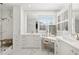 Bright bathroom featuring white cabinetry, marble floors, double vanity, and a glass-enclosed shower at 255 Marjean Way, Alpharetta, GA 30009